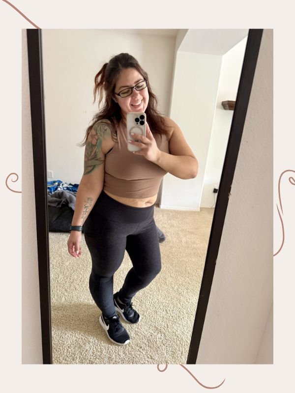 mirror selfie image of woman wearing tan cropped top and leggings