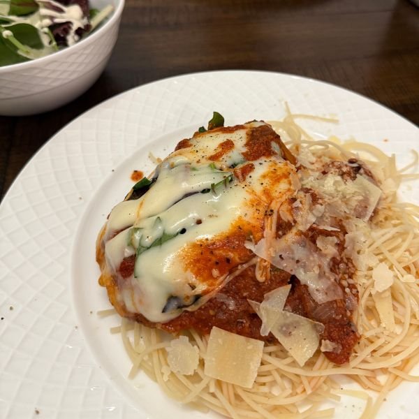 image of chicken parmesan on a white plate - part of easy dinners for busy moms article