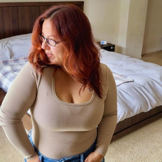 that mom karissa about me image2 image of karissa in bedroom standing with head turned looking out window