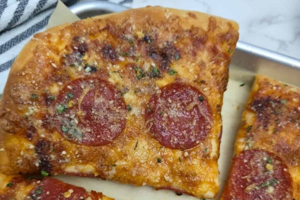 image of a slice of sheet pan pizza, recipe from simply scratch made