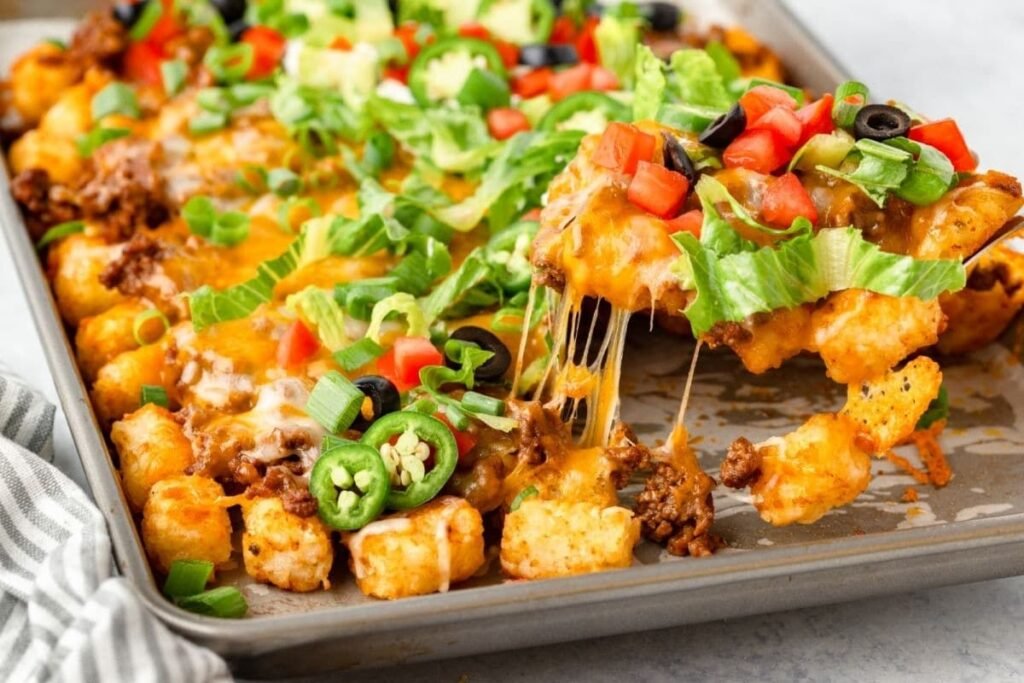 sheet pan totchos recipe - baked tater tots with toppings on a baking sheet