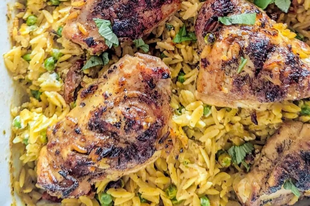 close up image of chicken and orzo sheet pan recipe seasoned and ready to serve