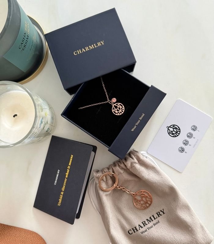 Flatlay image of Charmlry necklace and keychain